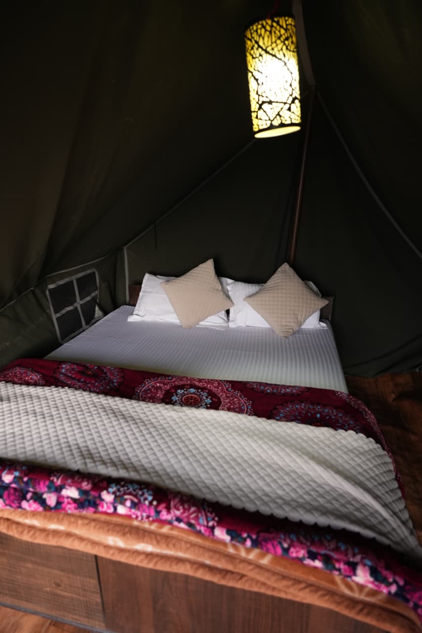 Valley View Compact Tent — cosy tent interior with warm pendant lamp and double bed